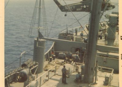 bodybags on the deck of the USS Liberty as Navy helicopter hovers