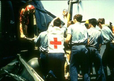 paramedics load injured Liberty crewman onto helicopter