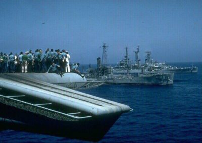 crew of USS America looking at damaged USS Liberty